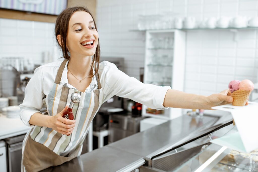 Woman selling ice cream in the shop