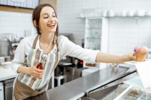Woman selling ice cream in the shop