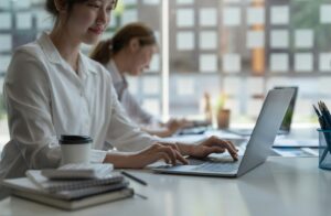 Close up busiess asian woman working with laptop computer for financial discussion calculation -